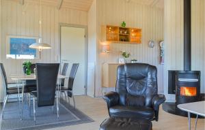 a living room with a chair and a table at Stunning Home In Hvide Sande With Kitchen in Havrvig