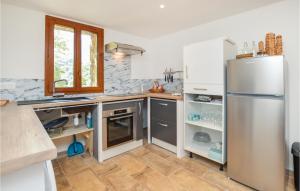 a kitchen with a stainless steel refrigerator at Awesome Home In Feliceto With House A Mountain View in Feliceto