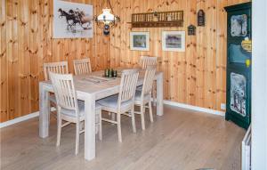 a dining room with a wooden table and chairs at Amazing Home In Eggedal With Sauna And 6 Bedrooms in Eggedal