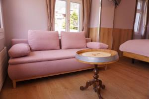 een woonkamer met een bank en een tafel bij Gasthof zur Bündte in Jenins