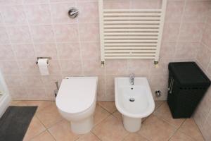a bathroom with a toilet and a bidet at Lovely Apartment near Canal - Via Foscolo in Corsico