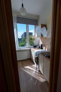 a kitchen with a large window and a kitchen counter at Trendy Kentmanni, city center apartment in Tallinn