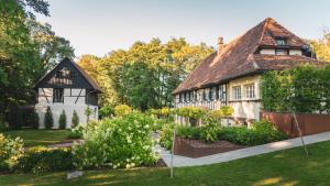 an old house with a garden in front of it at Domaine du Kaegy - Hébergements 5 étoiles in Steinbrunn-le-Bas