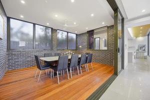a dining room with a table and chairs at Putney Brand New Luxury House Pool & Waterview in Sydney