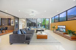 a living room with a couch and a fireplace at Putney Brand New Luxury House Pool & Waterview in Sydney