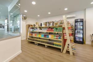 a store aisle with shelves of products in a store at Sol Puerto Marina in Torremolinos