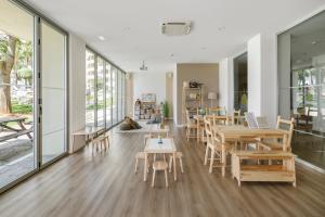 a large room with tables and chairs and windows at Sol Puerto Marina in Torremolinos