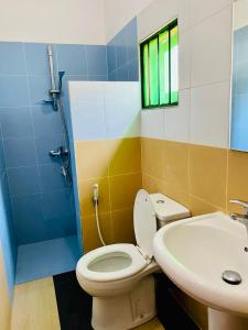 a bathroom with a toilet and a sink at Hotel 100 in Dehiwala