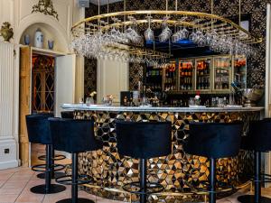 a bar with black bar stools in a room at Château de Candie in Chambéry