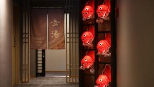 a wall of red lanterns in a room at Dormy Inn Aomori Natural Hot Spring in Aomori
