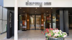 a building with a bunch of flowers in front of it at Dormy Inn Aomori Natural Hot Spring in Aomori