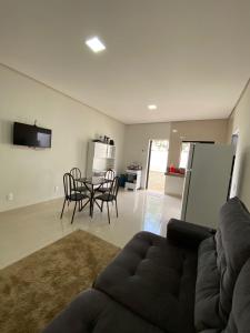 a living room with a couch and a table at Flat Dona D - Prox da JK in Palmas