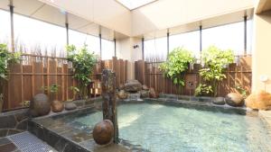 a hot tub in the middle of a house at Dormy Inn Aomori Natural Hot Spring in Aomori