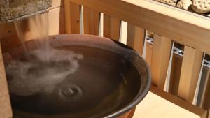 a wok with water in it sitting on a bench at Dormy Inn Aomori Natural Hot Spring in Aomori