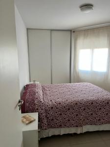 a bedroom with a bed and a window at Departamento Skala in Cordoba