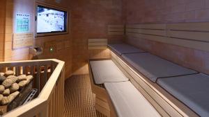 a sauna with two beds and a window at Dormy Inn Aomori Natural Hot Spring in Aomori