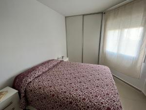 a bedroom with a bed and a window at Departamento Skala in Cordoba +13 photos