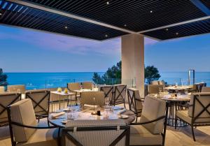 a restaurant with tables and chairs with a view at Grand Hotel Brioni Pula, A Radisson Collection Hotel in Pula