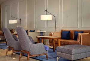 a lobby with chairs and a table and a couch at Grand Hotel Brioni Pula, A Radisson Collection Hotel in Pula