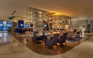 a lobby of a hotel with chairs and a table at Grand Hotel Brioni Pula, A Radisson Collection Hotel in Pula
