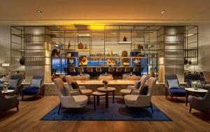 a lobby with a waiting room with chairs and tables at Grand Hotel Brioni Pula, A Radisson Collection Hotel in Pula