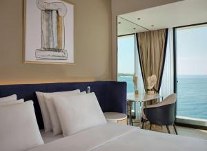 a hotel room with a bed and a table at Grand Hotel Brioni Pula, A Radisson Collection Hotel in Pula