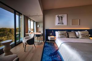 a bedroom with a bed and a table and a chair at Grand Hotel Brioni Pula, A Radisson Collection Hotel in Pula