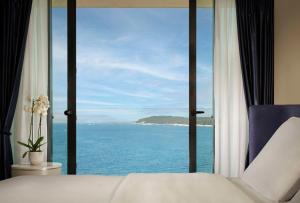 a bedroom with a view of the ocean at Grand Hotel Brioni Pula, A Radisson Collection Hotel in Pula