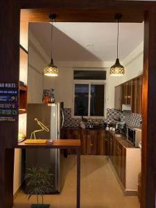 a kitchen with wooden cabinets and a stainless steel refrigerator at Yb home in Sonīpat