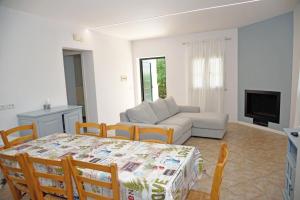 a living room with a table and a couch at Beachside House in Sperlonga