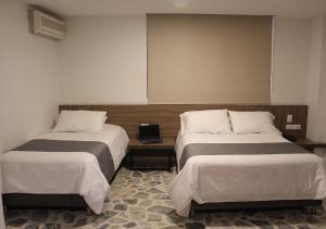 Letto o letti in una camera di Hotel D' Leon