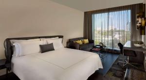 a bedroom with a white bed and a large window at Park Plaza London Waterloo in London
