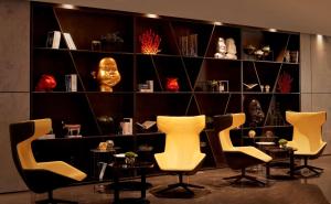 a room with chairs and a shelf with a mask at Park Plaza London Waterloo in London