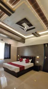 1 dormitorio con 1 cama grande con almohadas rojas en Hotel Goyal Palace, en Agra