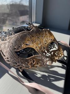 a gold mask sitting on top of a table at Såstaholm Hotell & Konferens in Täby