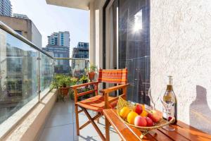 a balcony with a bowl of fruit and a bottle of wine at Cinnamon Residence in Nairobi