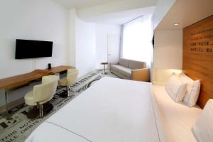 a hotel room with a white bed and a desk at Park Plaza Wallstreet Berlin Mitte in Berlin