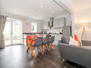 a kitchen and living room with a couch and a table at 1 Millbank in Keswick