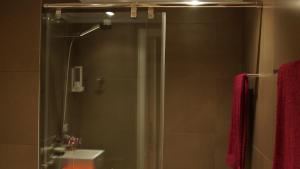 a bathroom with a shower with a sink and a mirror at La Bohemia Casco Antiguo 2 in Denia +12 photos