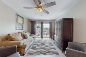 a living room with a couch and a ceiling fan at Perdido Dunes #20 in Orange Beach