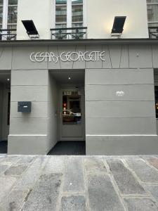 a building with a gray corporate sign on it at La Dépendance in Paris