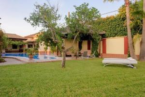 a villa with a garden and a swimming pool at Andalusian Villa w/ Pool, Garden & Barbecue in Écija