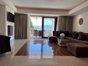 a large living room with a couch and a table at Villa Jade Apartments FRONT ROW SEA VIEW - WALK TO KORCULA OLD TOWN in Korčula