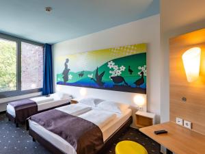 Postel nebo postele na pokoji v ubytování B&B Hotel Göttingen-City + 22 fotografií
