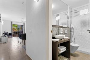 a bathroom with a sink and a toilet and a shower at Paloma Beach Apartments in Los Cristianos
