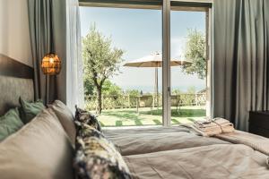 a bedroom with a bed and a large window at Privilegium Lazise in Lazise +60 photos