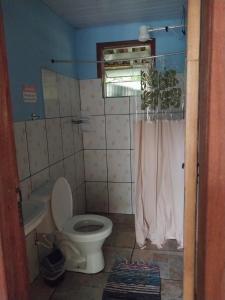 a small bathroom with a toilet and a shower at Hospedagem Caminho das Águas in Paraty +42 photos