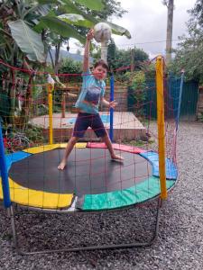 a young boy playing on a trampoline at Hospedagem Caminho das Águas in Paraty