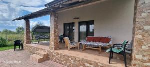 a patio with chairs and a table at Vila Catalina in Baia Mare