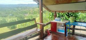 a kitchen with a table and a view of a mountain at Phu Aram Khao Kho Resort in Khao Kho